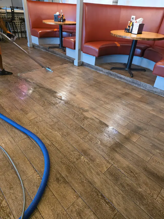 Our wand cutting a clean stripe across a restaurant's wood-look floor