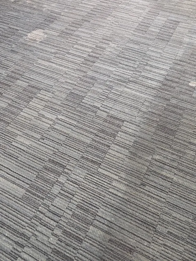 The same restaurant carpet tile after cleaning, even color with the pattern clear again